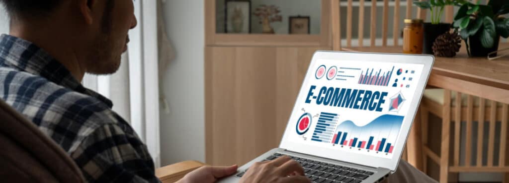 man on laptop researching ecommerce trends