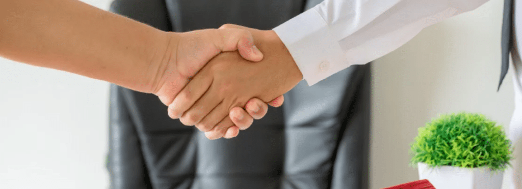 People shaking hands on deal