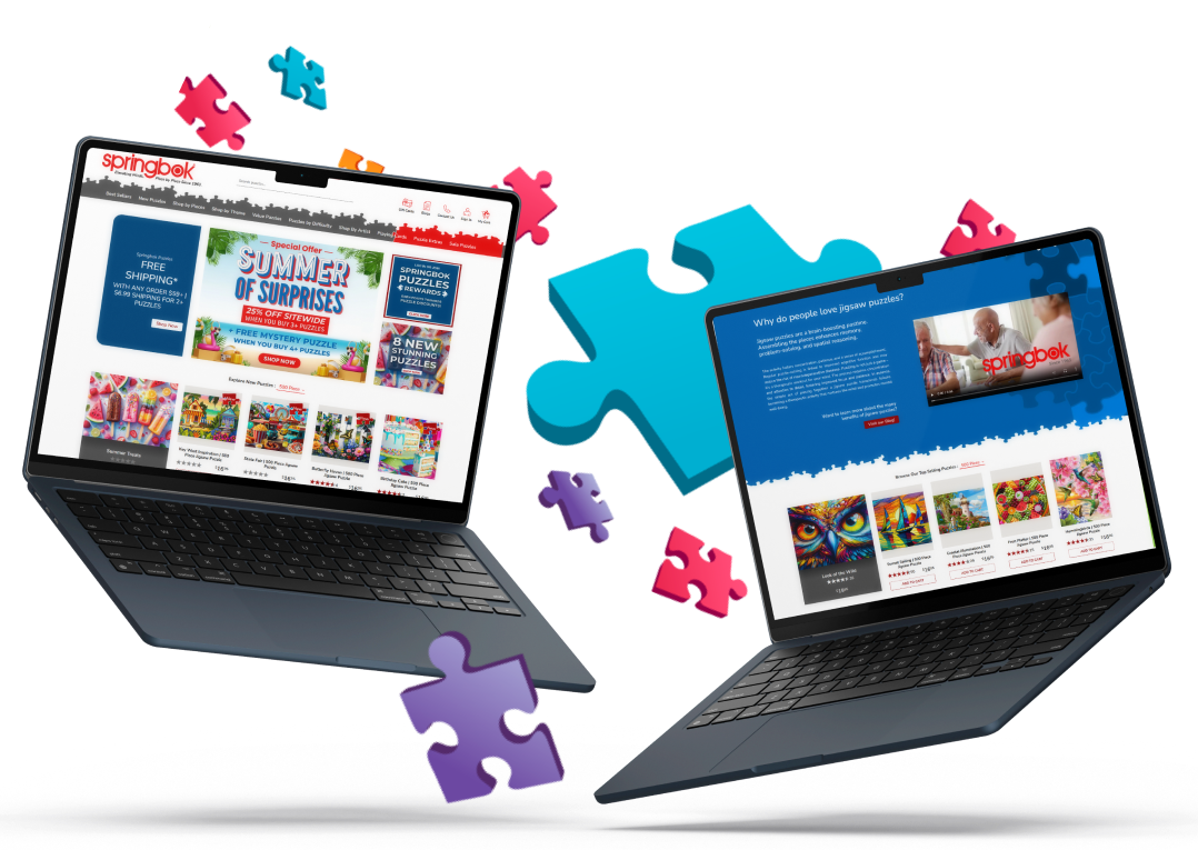  Two laptops displaying Springbok Puzzles BigCommerce headless redesign by MAKDigital, surrounded by colorful puzzle pieces representing their website.